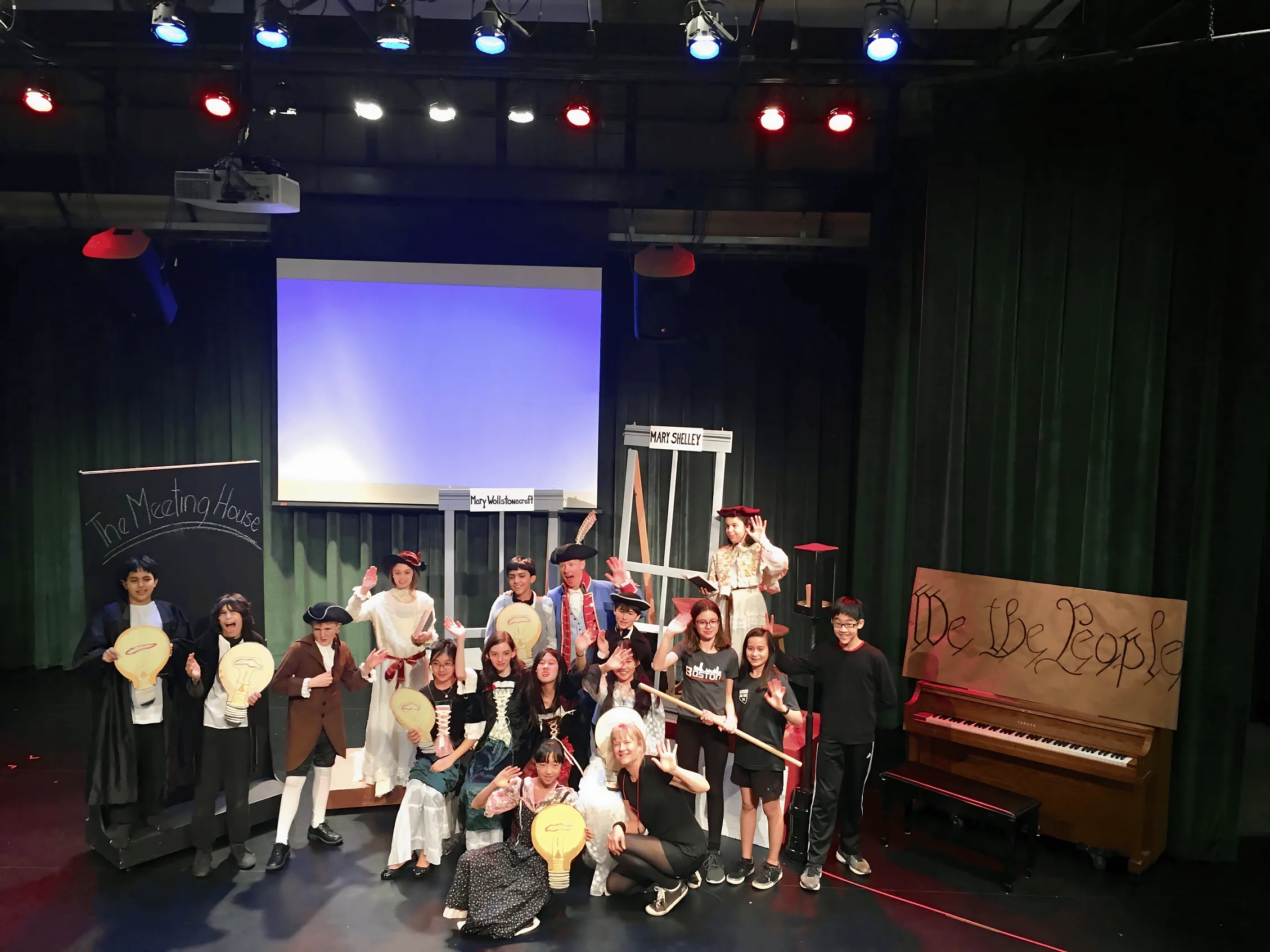 Students in costume on stage after a Sovereign Arts performance